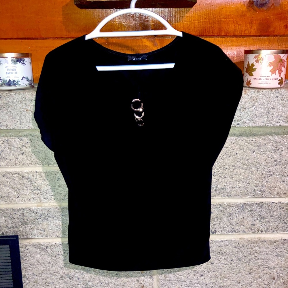 Black dress shirt with 3 gold rings in the middle front of the shirt.